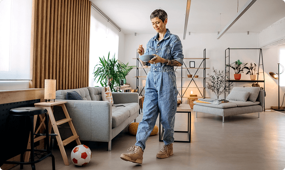 Woman Walking while eating from a Bowl